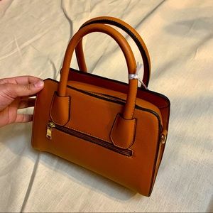 BURNT ORANGE LA TERRE PURSE WITH GOLD ACCENTS AND PURSE FEET